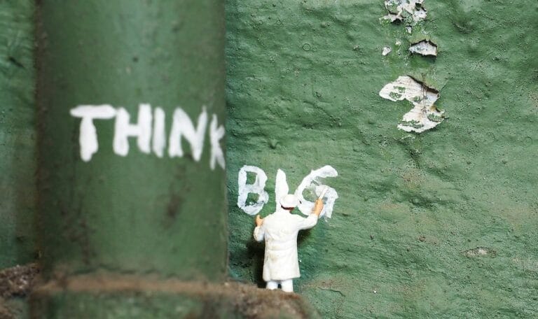 A green wall with the words think big painted on it